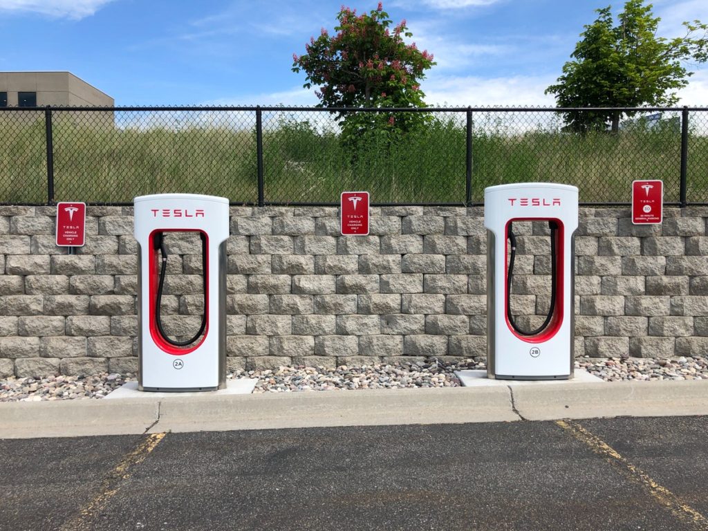 two-white-and-red-tesla-charging-station